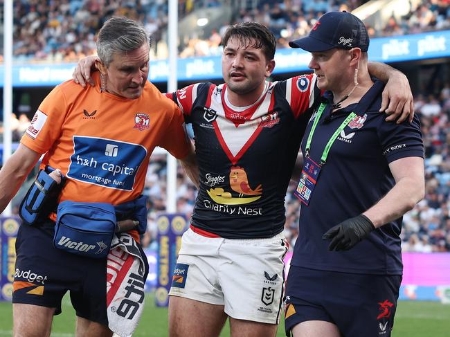 Brandon Smith limps from the field after rupturing his ACL. Picture: Cameron Spencer/Getty Images