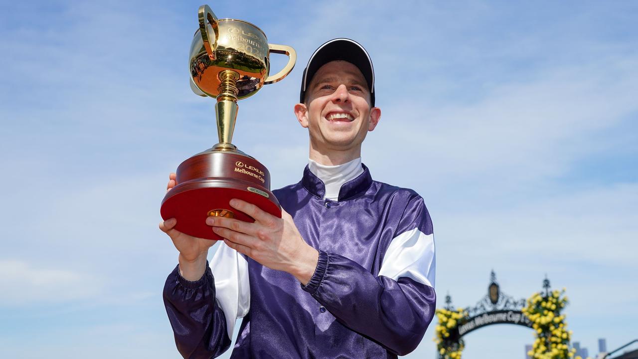 This handout photo taken and released on November 3, 2020 by Racing Photos shows Jye McNeil, who rode Twilight Payment of Ireland, celebrating with the trophy after winning the Melbourne Cup at Flemington Racecourse in Melbourne. (Photo by Scott Barbour / RACING PHOTOS / AFP) / XGTY / EDITORS NOTE ----RESTRICTED TO EDITORIAL USE MANDATORY CREDIT 