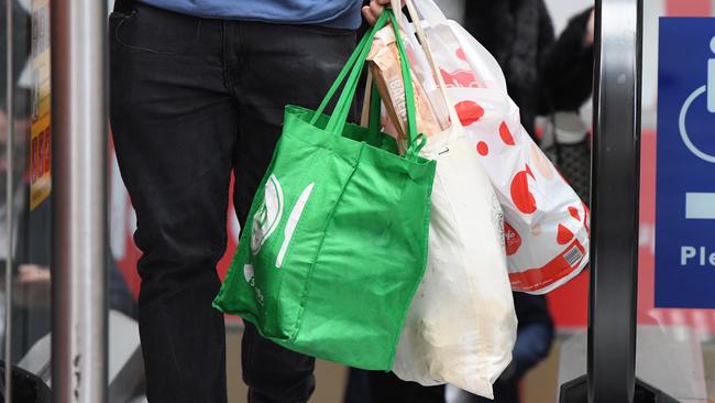 A shopper is seen carrying bags at a Coles Sydney CBD store, Sydney, Monday, July 2, 2018. Woolworths says it will hand out free reusable bags for the next 10 days as its customers get used to its ban on single-use plastic bags. Woolies stores in NSW, Queensland, Victoria and Western Australia stopped providing free single-use plastic bags on June 20. (AAP Image/Peter RAE) NO ARCHIVING