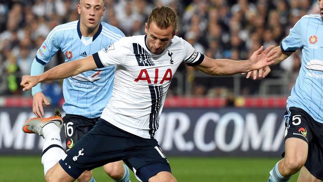 Tottenham Hotspur player Harry Kane (C) shoots as Sydney FC defenders Alexander Gersbach (L) and Matthew Jurman (R) look on in their friendly football match in Sydney on May 30, 2015. AFP PHOTO/William WEST --IMAGE RESTRICTED TO EDITORIAL USE - STRICTLY NO COMMERCIAL USE--