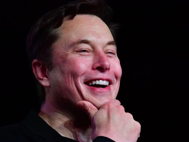 (FILES) In this file photo taken on March 14, 2019 Tesla CEO Elon Musk reacts during the unveiling of the new Tesla Model Y in Hawthorne, California. - Tesla's surging stock value has boosted Elon Musk further up the list of top billionaires as he stands poised for yet another massive payout as soon as this week. (Photo by Frederic J. BROWN / AFP)