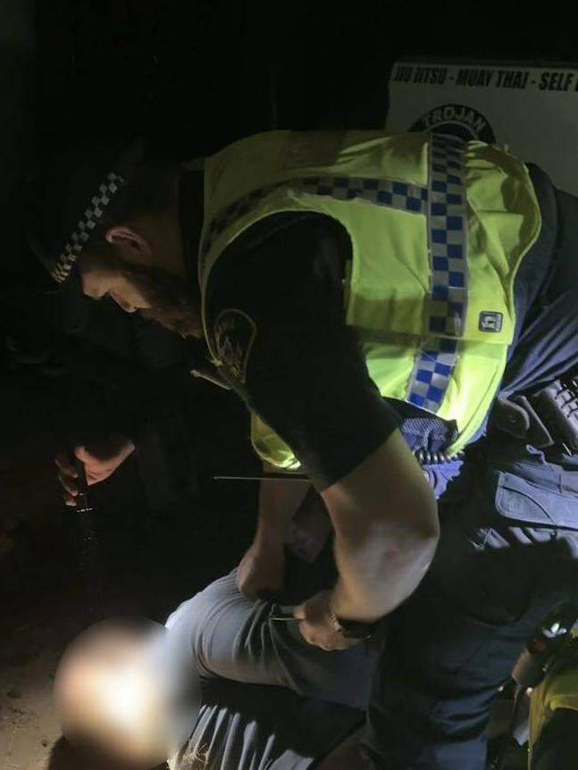 Tasmania Police officers arresting the alleged thief at the scene. Picture: Darran Petty/Facebook