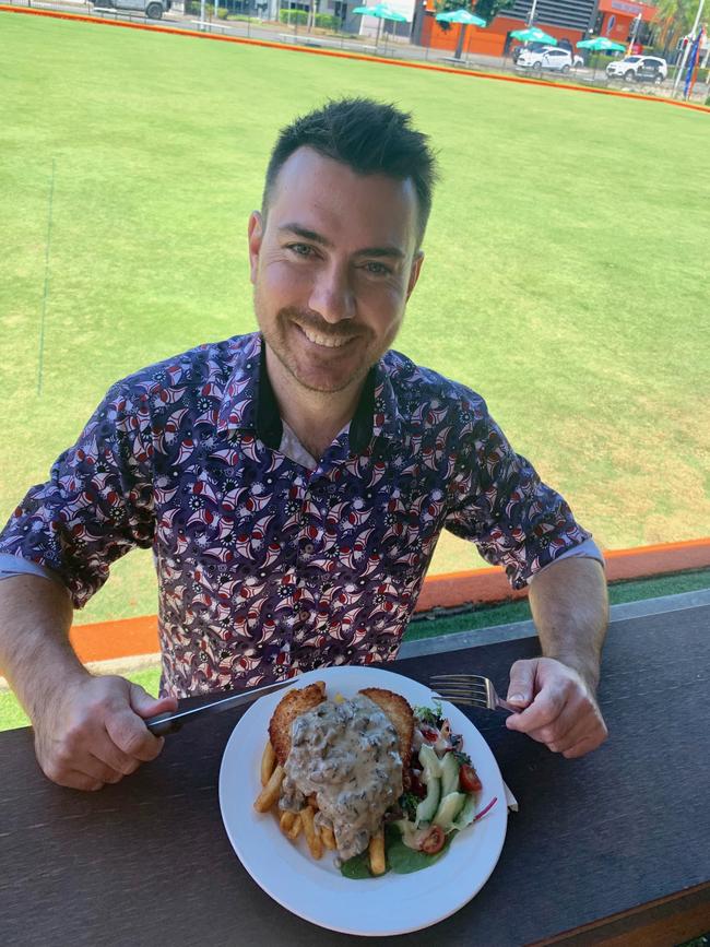 Newstead’s Booroodabin Community and Recreation Club — The Boo as it is affectionately known — operations manager Adam Watson tucks in to the handmade chicken schnitty. PHOTO: Abbie Bradshaw