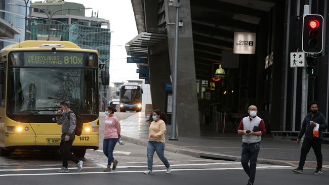 Pedestrians socially distance as they cross the street in the usually bustling shopping district of Parramatta in western Sydney. Picture: Getty Images