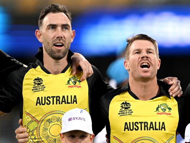 BRISBANE, AUSTRALIA - OCTOBER 31: Glenn Maxwell, David Warner and Aaron Finch of Australia embrace for their national anthem before the ICC Men's T20 World Cup match between Australia and Ireland at The Gabba on October 31, 2022 in Brisbane, Australia. (Photo by Bradley Kanaris/Getty Images)