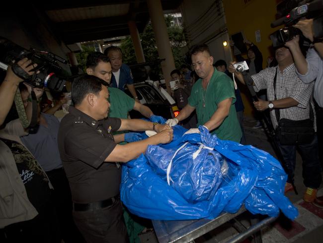 The body of slain British tourist David Miller, wrapped in plastic sheet, is carried at a forensic police facility in Bangkok, Thailand in September, 2014. Picture: Sakchai Lalit