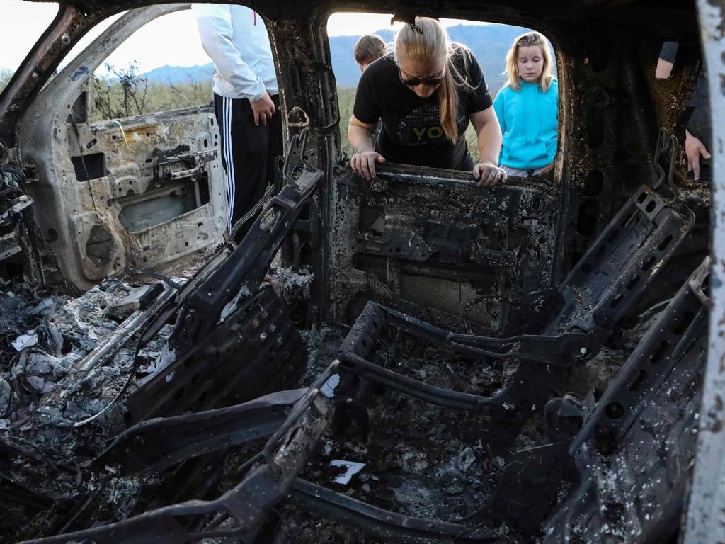 Family visit the murder site. Picture: Herika Martinez/AFP