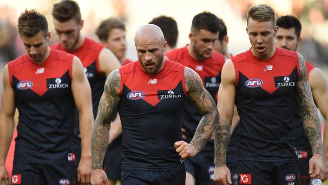 Nathan Jones leads Melbourne off after losing to St Kilda.