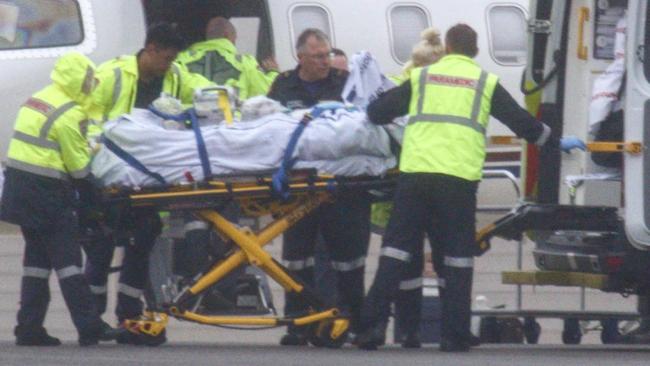 An injured person arrives at Victoria’s Essendon airport on Thursday. Picture: Paul Dowsley