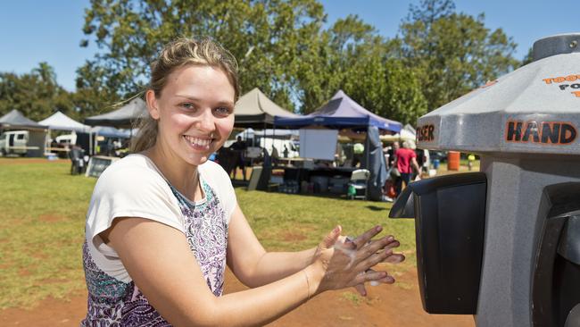 Laura Ayles of The Toowoomba Farmers Market uses the hand sanitiser dispenser placed by organisers as part of measures to reassure the public in the wake of the COVID-19 coronavirus pandemic, Saturday, March 21, 2020. Picture: Kevin Farmer