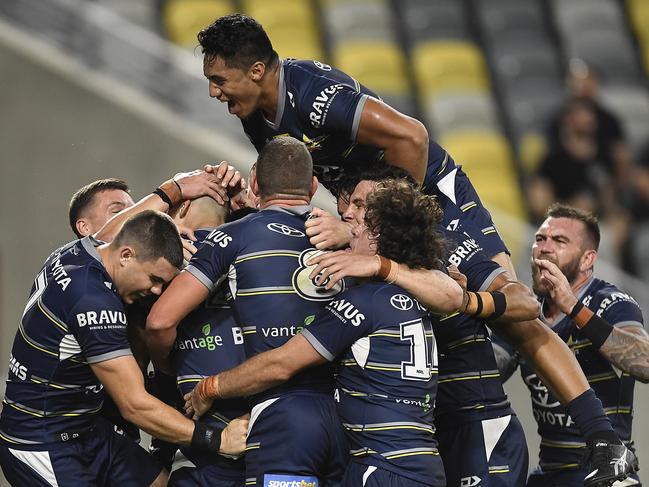 Heilum Luki is mobbed by Cowboys teammates. (Photo by Ian Hitchcock/Getty Images)