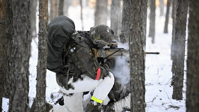 A soldier of the German armed forces Bundeswehr who are part of the German contingent of NATO's Enhanced Forward Presence, shoots during an exerice in a snow-covered forest on March 7, 2023 near Pabrade, Lithuania. Picture: AFP