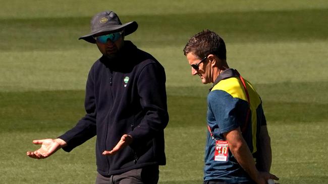 A curator explains the pitch prior to the abandonment the Sheffield Shield match between Victoria and Western Australia at the MCG in Melbourne, Saturday, December 8. Picture: AAP Sean Garnsworthy.