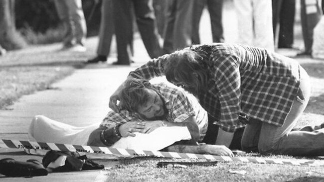 A man is comforted as he mourns the loss of a friend at the Milperra bikie massacre.