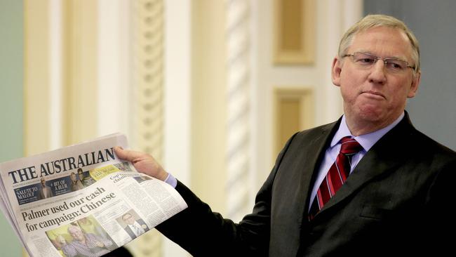 Queensland’s Deputy Premier Jeff Seeney holds up The Australian’s front page in parliament. Picture: Mark Cranitch