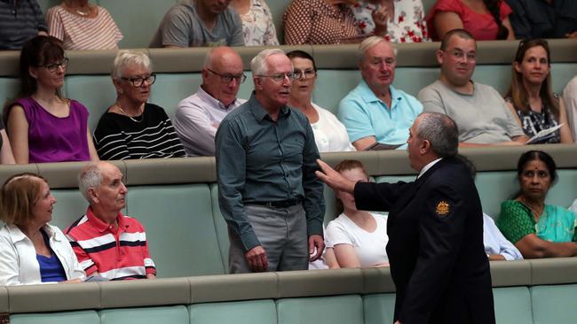 A protester stands and interrupts Question Time. Question Time in the House of Representatives. 