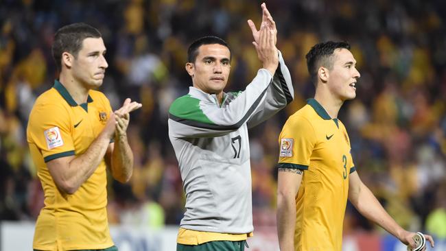 (L-R) Mathew Leckie, Tim Cahill and Jason Davidson of Australia celebrate beating United Arab Emirates in their AFC Asian Cup semi-final football match in Newcastle on January 27, 2015. AFP PHOTO/Peter PARKS --IMAGE RESTRICTED TO EDITORIAL USE - STRICTLY NO COMMERCIAL USE