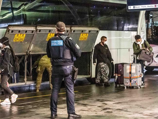 Arrivals are transported by authorities to hotel quarantine in Sydney. Picture: Monique Harmer