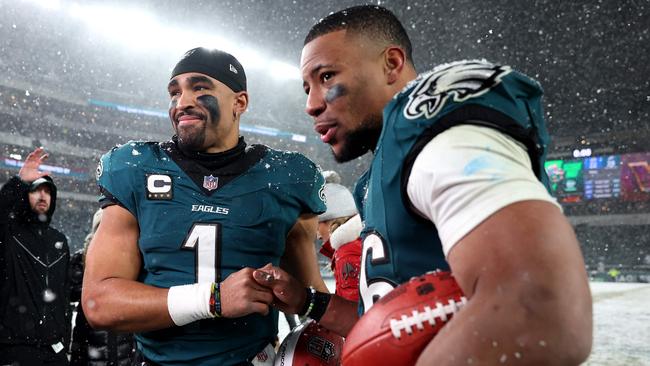 PHILADELPHIA, PENNSYLVANIA - JANUARY 19: (L-R) Jalen Hurts #1 and Saquon Barkley #26 of the Philadelphia Eagles react after defeating the Los Angeles Rams 28-22 in the NFC Divisional Playoff at Lincoln Financial Field on January 19, 2025 in Philadelphia, Pennsylvania.   Sarah Stier/Getty Images/AFP (Photo by Sarah Stier / GETTY IMAGES NORTH AMERICA / Getty Images via AFP)