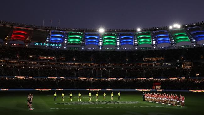 Teams line up before the start of the round 12 AFL match between the Essendon Bombers and the Richmond Tigers at Optus Stadium in Perth, Australia.