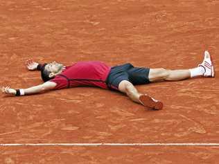 CLAY FEAT: A relieved Novak Djokovic tries to take in his win in the French Open. Picture: Christophe Ena