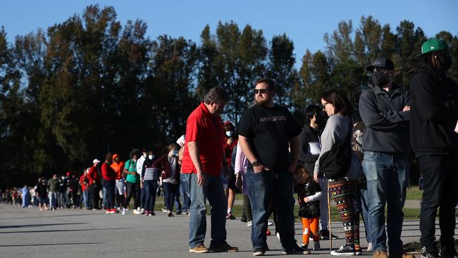 Hundreds of people lined up for over an hour to cast their ballot in Georgia, as record early-voting numbers could limit the impact of the national slowdowns in mail delivery. Picture: Getty