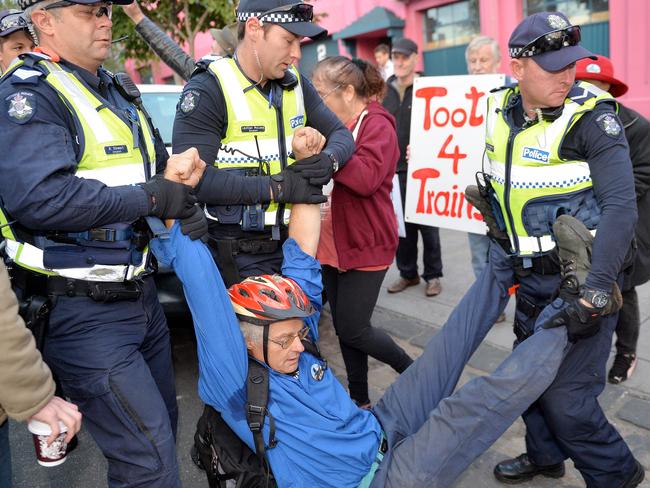 Tony Murphy is removed from Queens Parade by police during a protest against the East West Link. Picture: Nicole Garmston