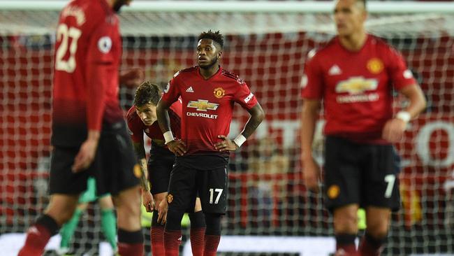 Manchester United's Brazilian midfielder Fred (C) reacts with team-mates after Tottenham's third goal during the English Premier League football match between Manchester United and Tottenham Hotspur at Old Trafford in Manchester, north west England, on August 27, 2018. (Photo by Oli SCARFF / AFP) / RESTRICTED TO EDITORIAL USE. No use with unauthorized audio, video, data, fixture lists, club/league logos or 'live' services. Online in-match use limited to 120 images. An additional 40 images may be used in extra time. No video emulation. Social media in-match use limited to 120 images. An additional 40 images may be used in extra time. No use in betting publications, games or single club/league/player publications. /