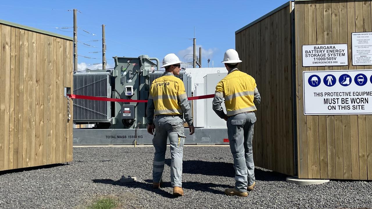 Mitch Anderson of Ergon Energy and Oliver Durieu of Yurika – Energy Queensland in front of the Bargara batteries.