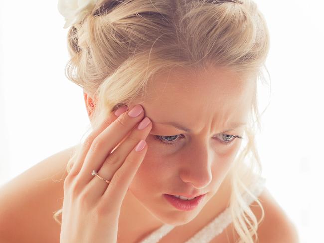 Worried bride looking at tablet