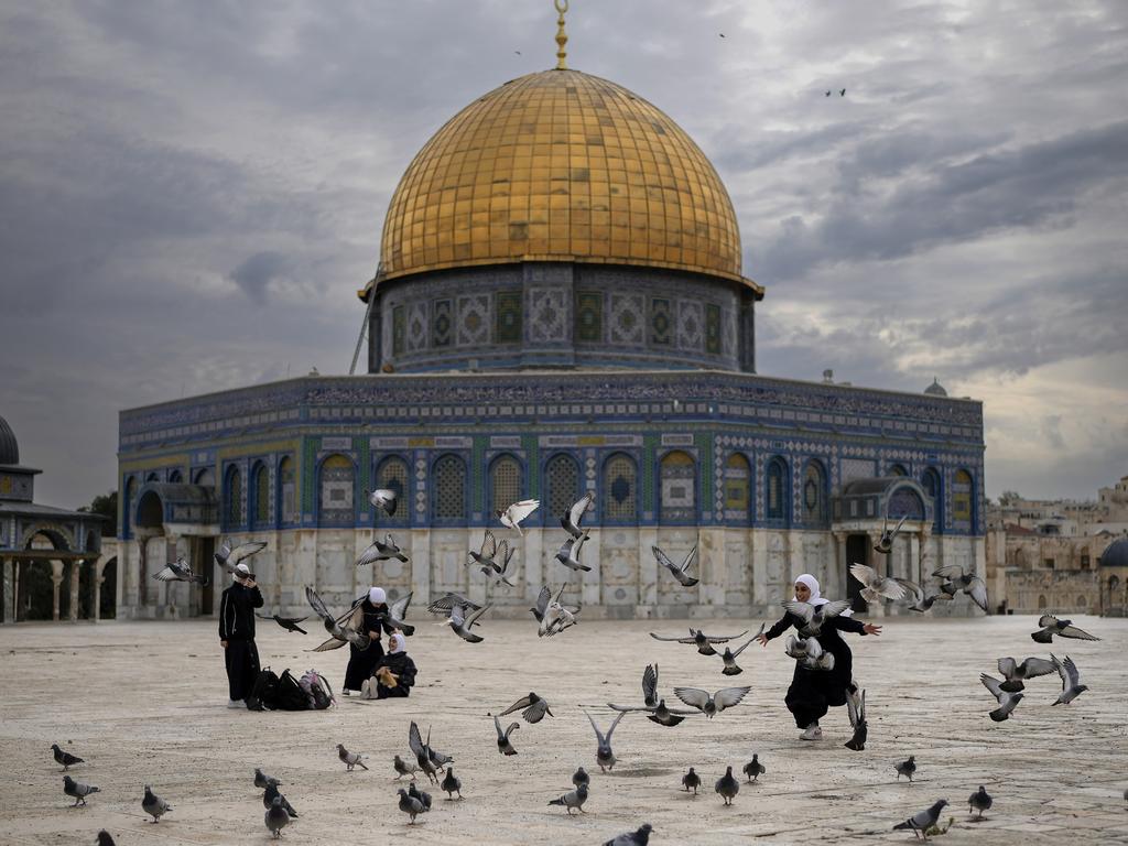 Children chase pigeons outside the deserted Al-Aqsa Mosque in Jerusalem, which is the third-holiest site in Islam. Picture: Christopher Furlong/Getty Images