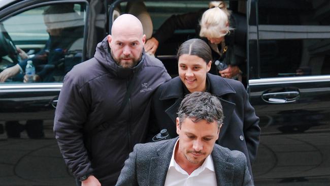 Matilda captain Sam Kerr arrives with her brother Levi and other family members, escorted by security into Kingston Crown Court. Picture: Jacquelin Magnay