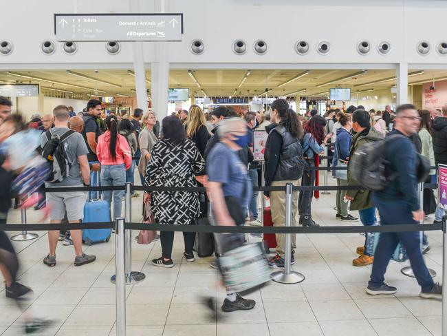 OCTOBER 11, 2022: Passengers queue to be screened at Adelaide Airport after being evacuated due to a security breach. Picture: Brenton Edwards