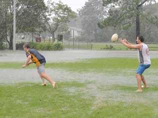 Bored with being stuck inside, Liam McIntyre and Andrew Mirkovic of Alstonville defied the storm to play a game of football at Geoff Watt Oval in Alstonville. Picture: Cathy Adams