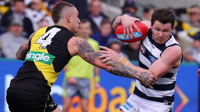 Patrick Dangerfield tries to break through a Dustin Martin tackle. Picture: Michael Klein