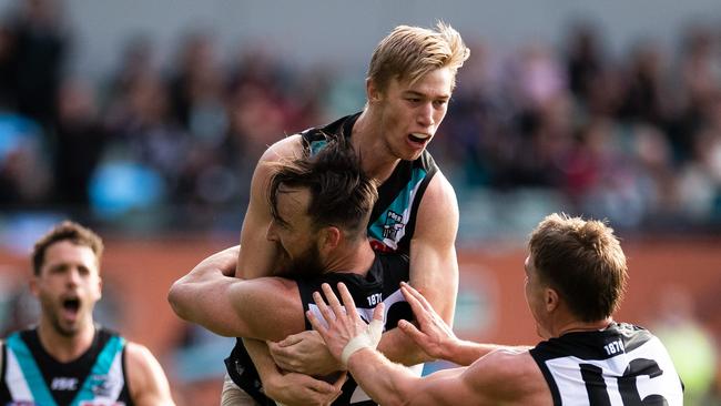 Port’s Todd Marshall congratulates teammate Charlie Dixon after Dixon kicked a goal against the Swans on Saturday. Picture: Getty Images