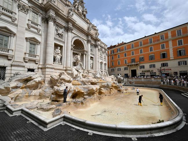 Workers clean the Trevi Fountain in Rome, which is drained twice a month for maintenance. Coins thrown by tourists are collected twice weekly. Picture: Alberto Pizzoli/AFP