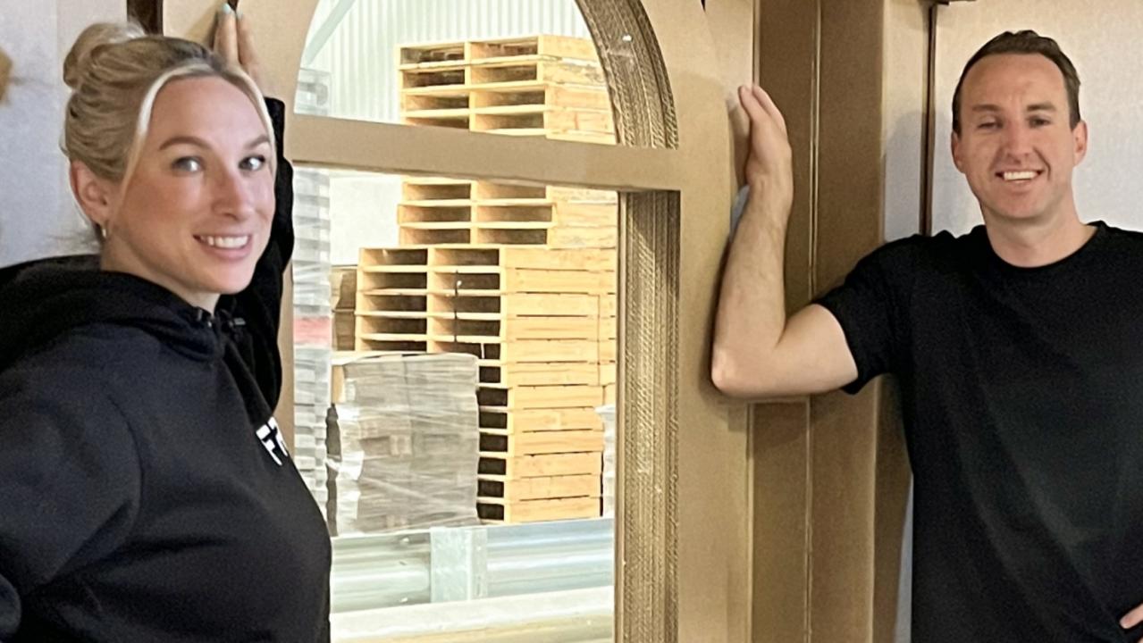 Jesse Raeburn and Mel Manson from The Block with cardboard house by Enphase solar headed to All Energy expo in Melbourne - for herald sun real estate