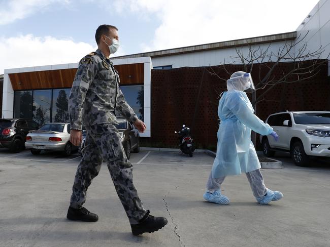 Military personnel and a medical staff at a Victorian aged care facility. Picture: Darrian Traynor/Getty Images