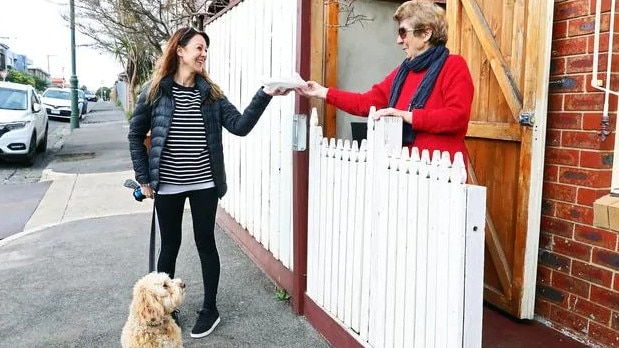 Soula Ikonomopoulos, of Brunswick, visiting her 80-year-old mother, Irine Ikonomopoulos, in the lockdown suburb of Brunswick West. Picture: Aaron Francis