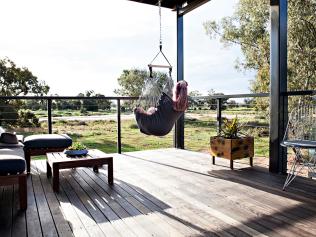 Woman relaxing in a hammock with views across the countryside during a stay at Callubri Station, Buddabadah.Credit: Monique Wyeescape15 august 2021cover story luxury farm stays