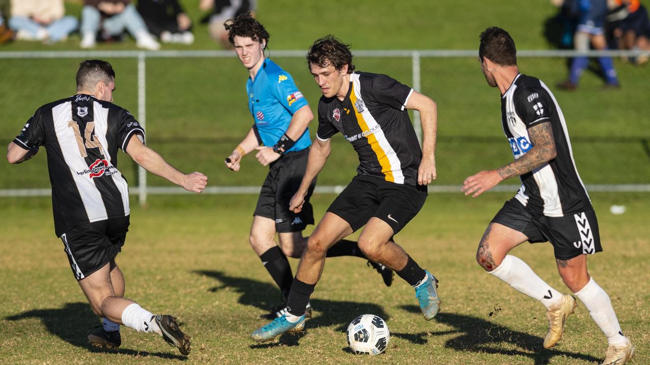 Callum Zadow (centre) of West Wanderers under pressure from Shaun Morley (left) and Trent Ingleton of Willowburn in FQPL Men Darling Downs Presidents Cup football at West Wanderers, Sunday, July 24, 2022. Picture: Kevin Farmer