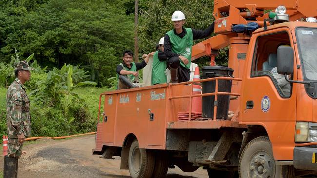 A Thai soldier stands at the roadside as a truck leaves the Tham Luang cave area as the clean-up continues. Picture: AFP’ Tang Chhin Sothy