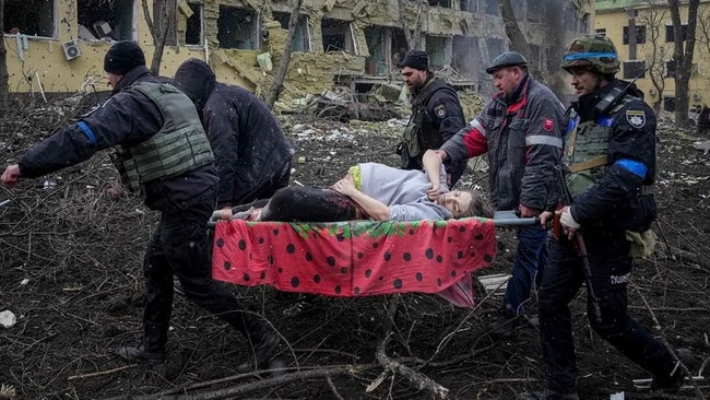 Rescuers carry a wounded person after the shelling of the Mariupol maternity hospital. Picture: AP