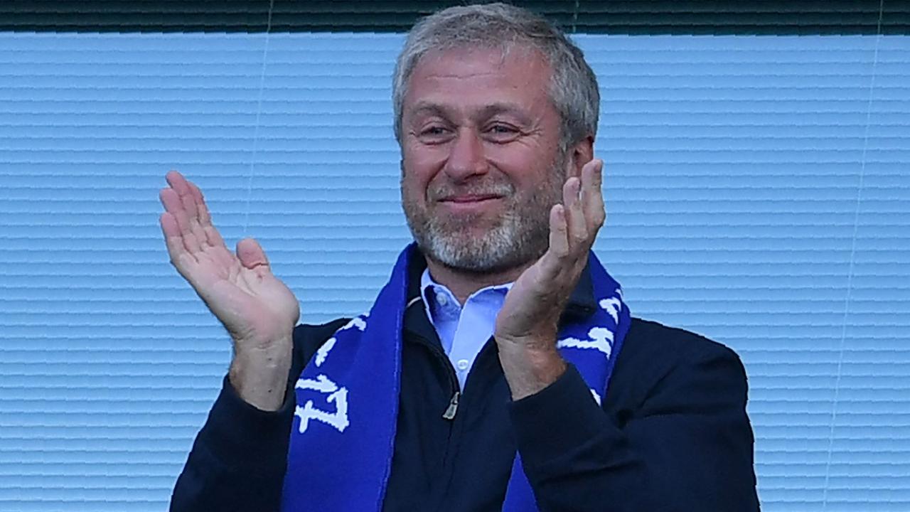 Chelsea's Russian owner Roman Abramovich applauds, as players celebrate their league title win. Photo by Ben STANSALL / AFP.