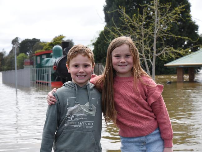 Blake and Madi How (kids wearing gumboots) at a flooded Deloraine Train Park. Picture: Alex Treacy