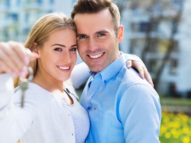 First home buyers purchasing a new property. Holding keys at the front of the property. Picture: iStock.