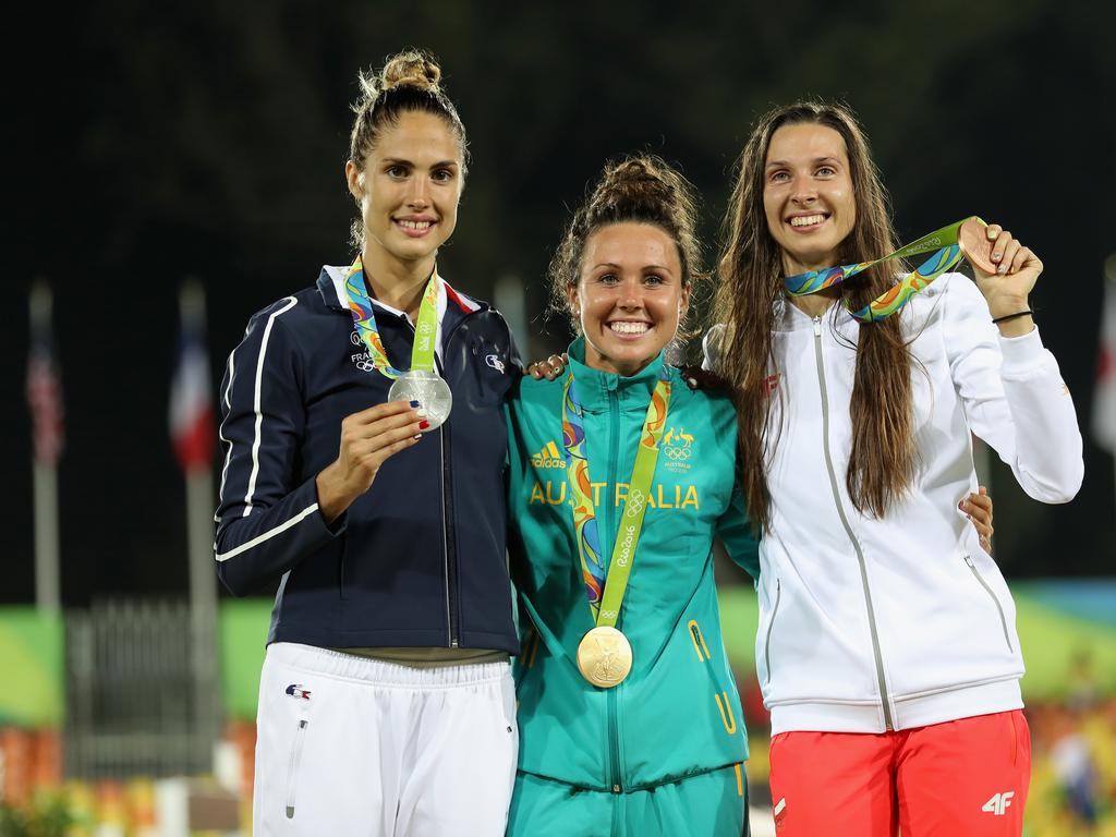 Silver medalist Elodie Clouvel of France, gold medalist Chloe Esposito of Australia and bronze medalist Oktawia Nowacka of Poland pose on the podium during the medal ceremony for the women’s modern pentathlon.