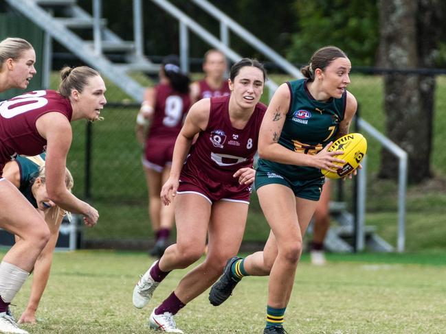 Tasmanian midfielder Perry King busts clear with the ball against Queensland at Bond University. Picture Aaron Black AFLQ Media.