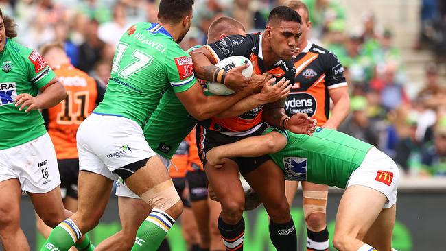 CANBERRA, AUSTRALIA - MARCH 14: Alex Twal of the Tigers is tackled during the round one NRL match between the Canberra Raiders and the Wests Tigers at GIO Stadium, on March 14, 2021, in Canberra, Australia. (Photo by Mark Nolan/Getty Images)